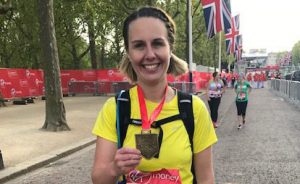 Online running coach helps runners achieve their goal. A photo of a runner at the finish of the London Marathon
