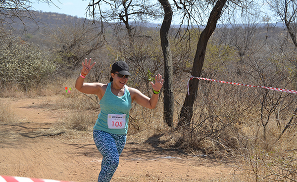 Online running coach helps runners achieve their goal. A photo of a runner on a trail run in Botswana