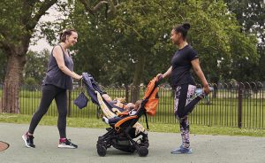 two women with pushchairs, stretching after taking part in a pre and post natal fitness session